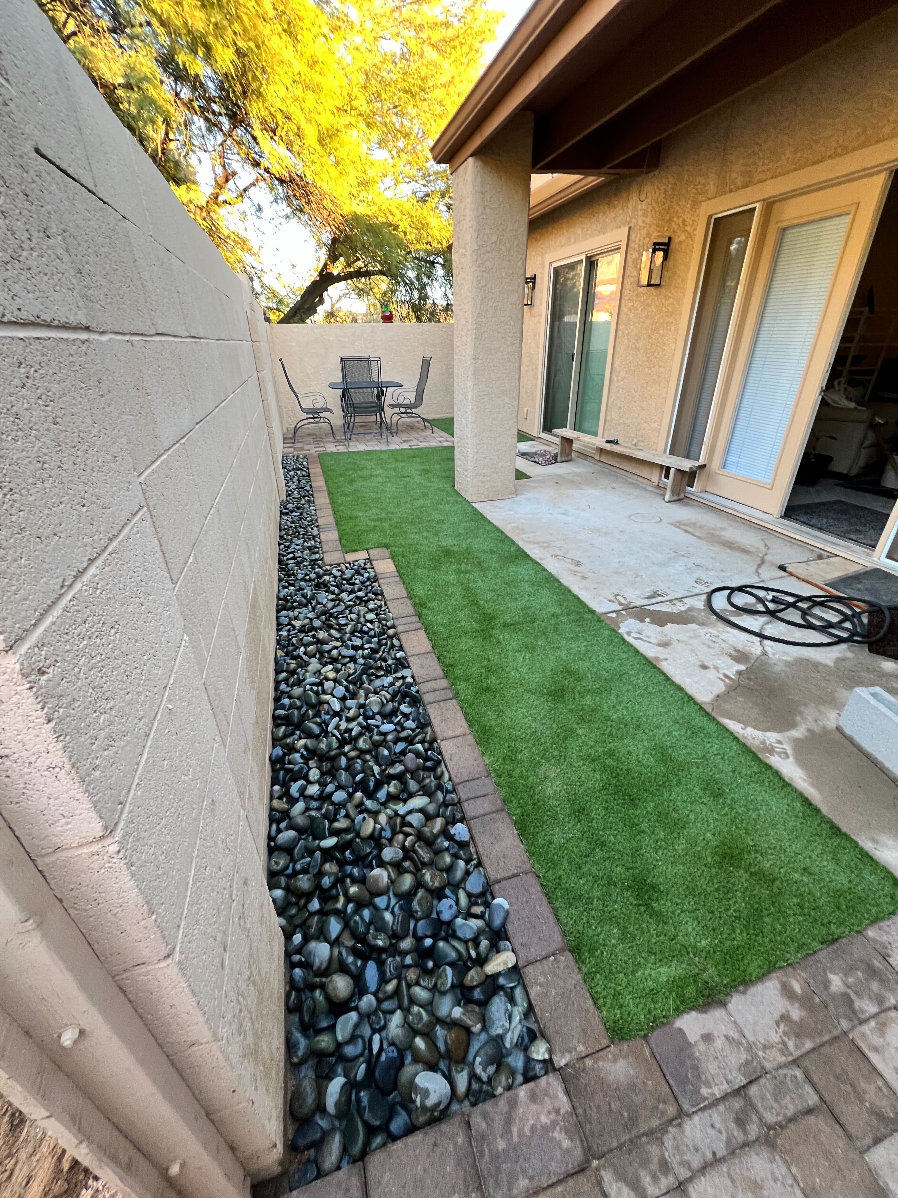 Side yard with turf and pavers